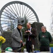 The Prince of Wales meets Alan Jones (left)chairman of Gresford disaster memorial and George Powell, lead volunteer at the Wrexham Miners Project during a visit to Gresford Colliery Disaster Memorial.