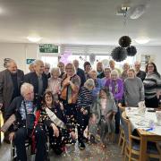 Kath Riley (front left) celebrating her retirement with staff and clients at Deva House.