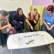 Sacha Arden, Carolyn James, Nicci Roberts and Erica Wilson looking at the Nightingale House garden plans.