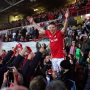 Wrexham's Paul Mullin celebrates with fans after winning promotion last season.