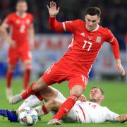 Wales' Tom Lawrence (left) and Denmark's Henrik Dalsgaard battle for the ball during the UEFA Nations League, Group B4 match at the Cardiff City Stadium.