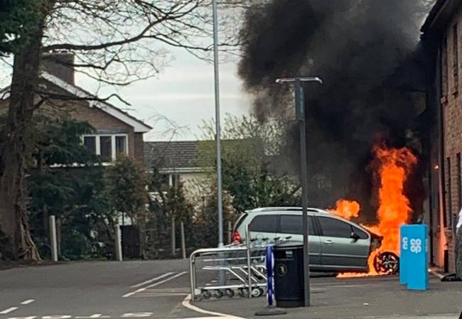 The car went up in flames in the car-park of the Co-op store in Rossett. Picture: Twitter / Molly Jones